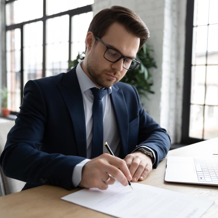 man signing contracts